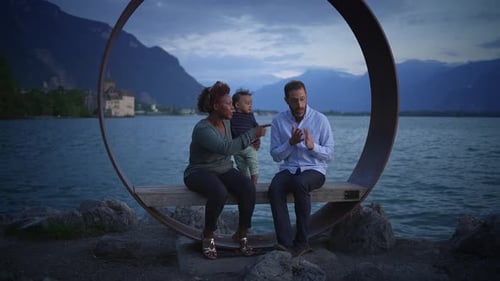 A Joyful Family Experience By the Lake at Dusk Embracing Nature and Bonding Together