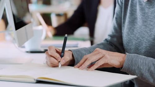 Office Workers Typing and Writing at Desk