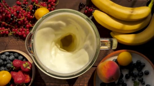Top View Lots of Fruits and Fresh Berries Mix in a Blender with Milk to Make a Bvnnnew Milkshake