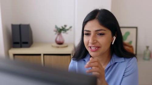 Closeup View of Young Indian Woman Talking on Laptop Video Call in the Office
