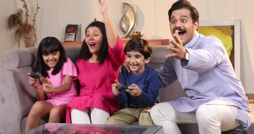 Happy Family Gaming at Home on Couch