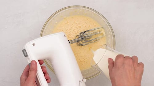 Electric Mixer Making Baking Ingredients in Clear Bowl