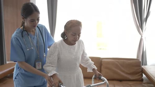 Woman Helping Senior with Walker in Home