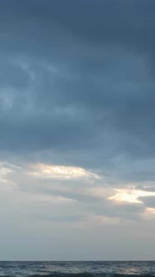 Sky clouds moving over stormy sea. Amazing stormy cloudscape. Vertical video