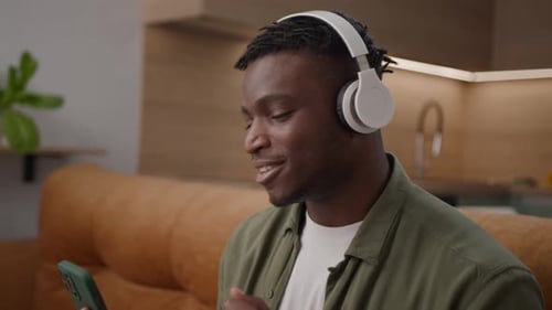 Man Listening to Music with Headphones and Smartphone