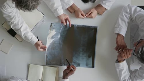 Medical Team Analyzing X-Ray in Bright Office