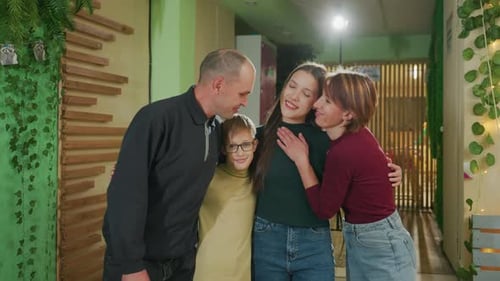 Happy Family Poses for Picture in Indoor Setting