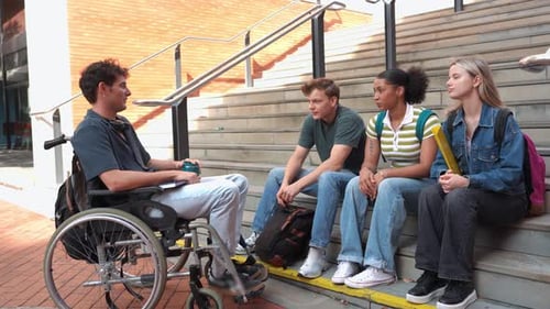 Disabled Student in Wheelchair Talking with Friends on Campus Stairs