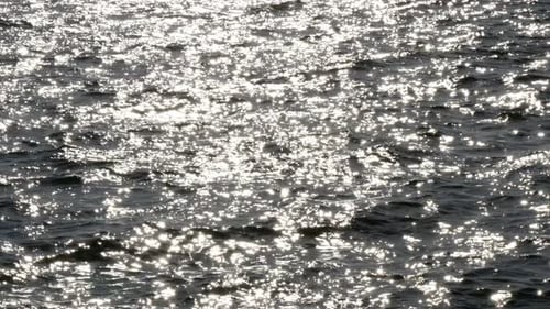 Sparkling Sunlight Reflections on Ocean Water Surface