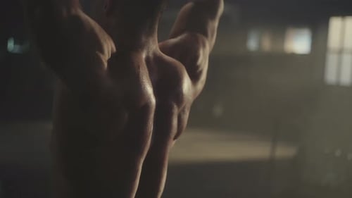 Man lifting weights over his head