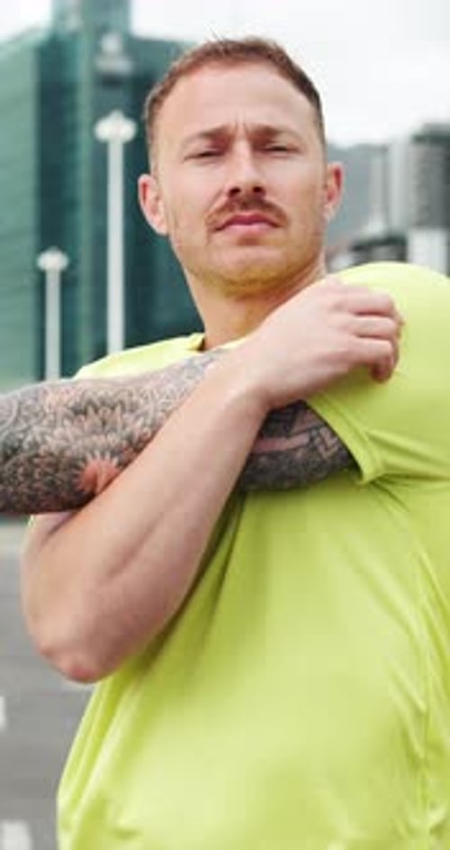 Sports, workout and man stretching arms in city for health, wellness or training for challenge