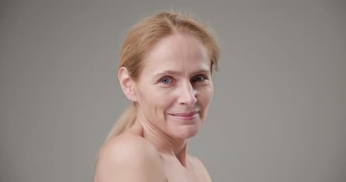 Elegant Blonde Woman Smiling in Studio Close-up