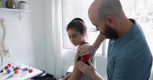 Teen Getting Shoulder Treated by Medical Professional