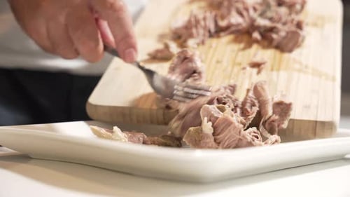 Serving shredded meat.