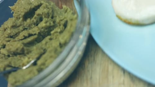 Preparing Healthy Vegan Avocado Toast Smear Mashed Avocado on Whole Grain Rye Bread Closeup View
