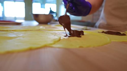 Applying Chocolate To Dough For Tasty Dessert