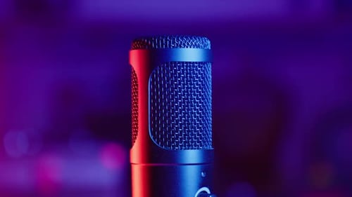 Microphone in Red and Blue Lights Rotating at Dark Background