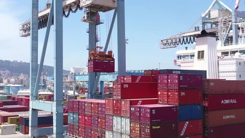 Shipping Container loaded by a Gantry crane onto a large Container Ship.
