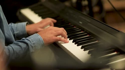 A man playing the piano in the studio