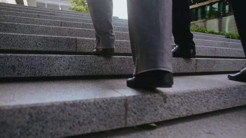 Business Partners Go Upstairs in Urban Setting Closeup