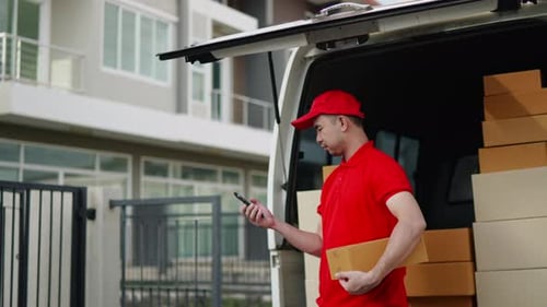 Delivery man, driver calling to customerr for sending parcel box package in the cargo truck at home