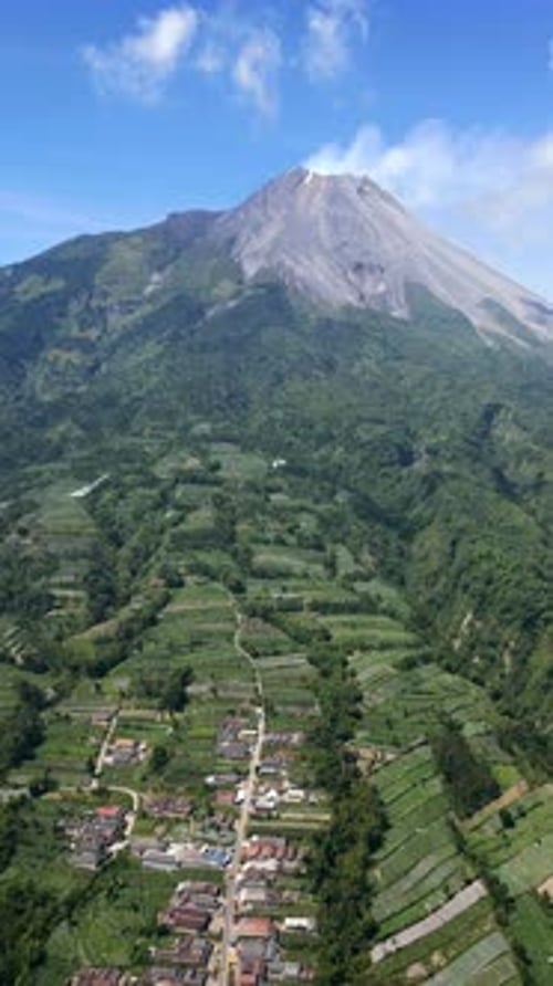 Rural Village with Traditional Houses and Mount Merapi Volcano Indonesia