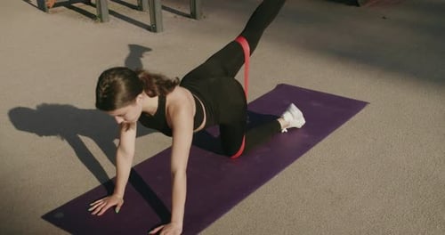 Woman Working Out With Resistance Band Outdoors