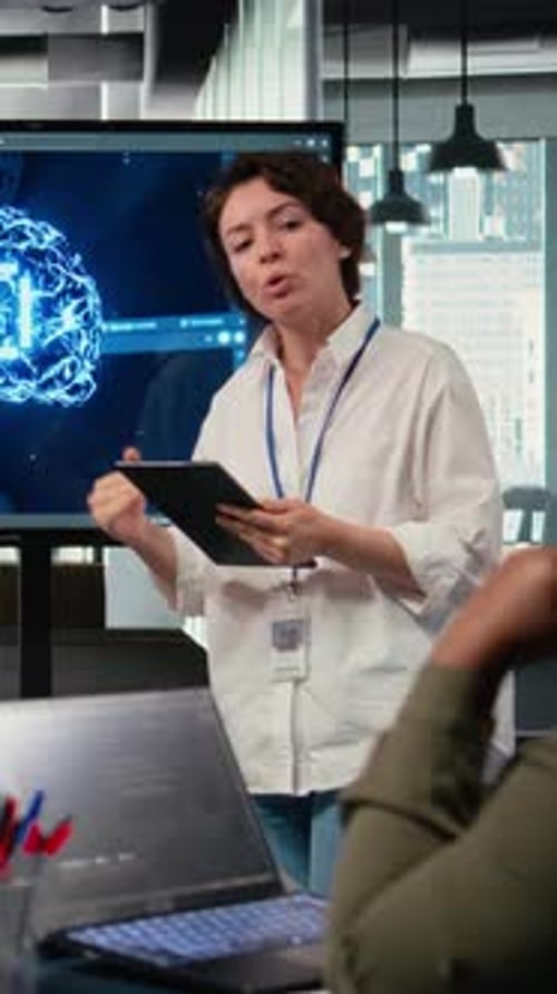 Woman Presents Tech Data with Tablet in Modern Office