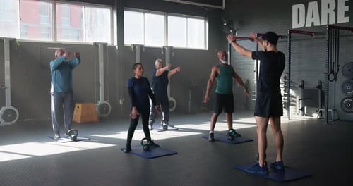 Fitness, gym and personal trainer with senior people for training, exercise and warm up for workout