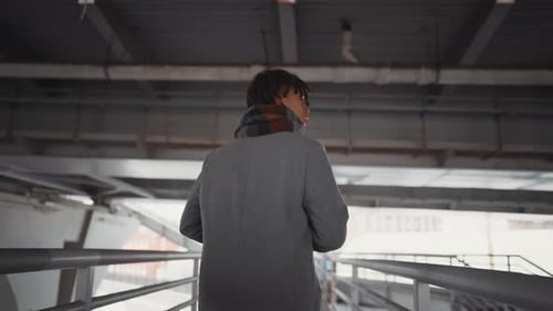 Back View of African Man in Grey Coat Walking Alone in City Autumn Melancholy Selfconfident Male