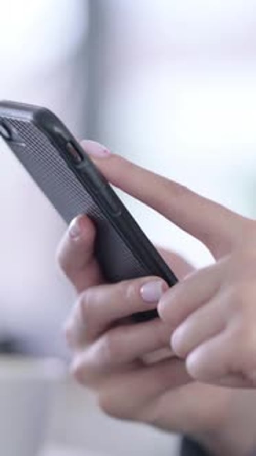 Close up of Hands of Female using Smartphone, vertical video