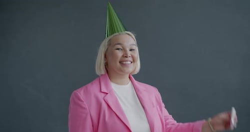 Woman Celebrating Birthday Blowing Party Favor