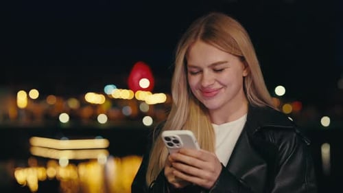 Woman Using Mobile Phone at Night in City
