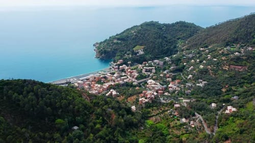 Small Mediterranean harbor town on the edge of a mountain range,drone aerial