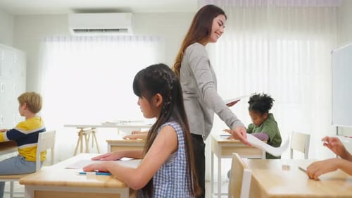 Group of student learn with teacher in classroom at elementary school.
