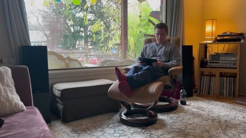 Adult Relaxing at Home, Using Tablet