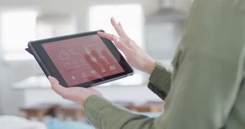 Woman Interacts with Tablet Smart Home Application
