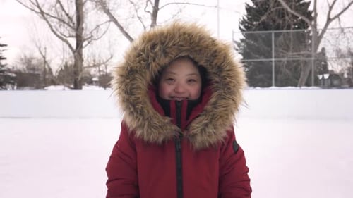 Smiling Woman with Fur Hood on Snowy Day