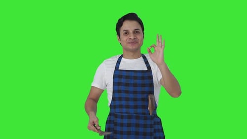 Happy Indian cook tasting good food and showing okay sign Green screen