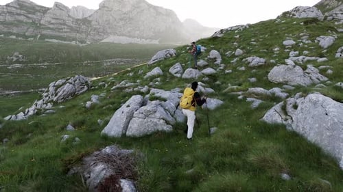 Hikers Climbing Rocky Mountain Path