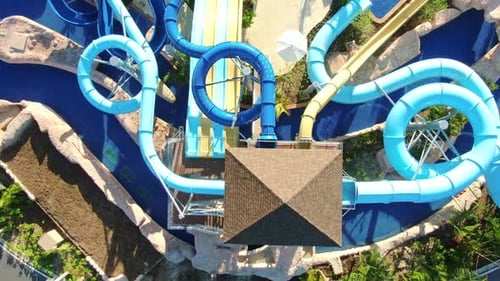 Top down view of aqua park with water slides in luxury tropical vacation resort, watersports and fun