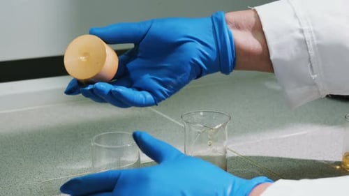 Closeup Lab Assistant Opens Bulb and Holds Cap on Palm