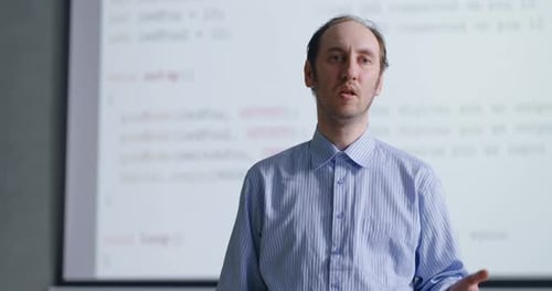 Portrait Of MiddleAged School Teacher In Classroom Of Programming And Computer Science