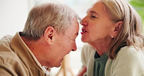 Loving Senior Couple Kissing Forehead