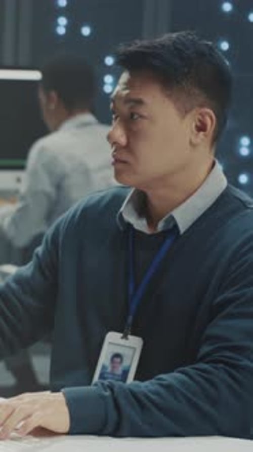 Man Working on Computer in Data Center