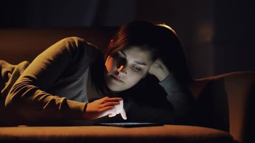 4k video footage of a woman using a digital tablet at home