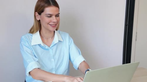 Happiness young businesswoman using laptop computer on desk in living room at home office.