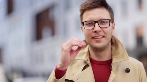 Smiling Man with Glasses Talking Outdoors