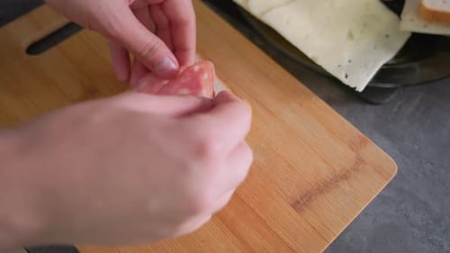 Making a Sandwich with Salami and Cheese