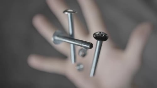 Metal Bolts and Nuts Falling in Slow Motion
